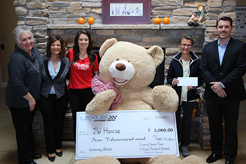 Giant Teddy Bear Delivers $5,000 Check to JW House in a Silver Lexus Convertible
